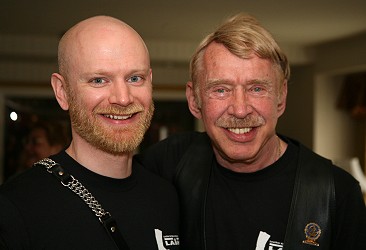 John and Chuck Renslow, side by side, smiling at the camera