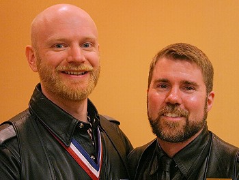 Headshot of John and Scott, side by side, smiling at the camera