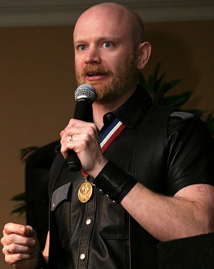 John on stage wearing his IML medal