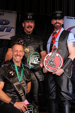 The three winners at the end of the contest, holding up their titleholder patches