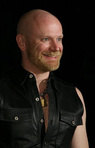 John wearing a black leather shirt