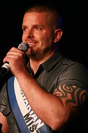 Close up of Mr Bavarian Leather holding a microphone and gazing at the crowd