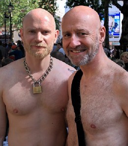 Dave and John, bare chested, standing together in Leicester Square