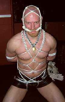 John tied up in a white rope harness