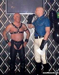 Colour photo of John onstage during the Mr Belfast Leather contest
