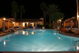 View of the swimming pool at Los Almendros at night