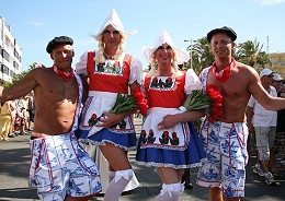 Four men dressed as two men and two women in traditional Dutch dress